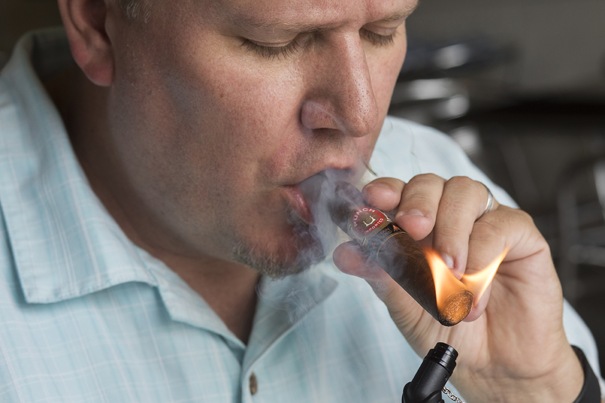 Tyler Omoth lights up a Punch Gran Puro Santa Rita that cost $5.49.