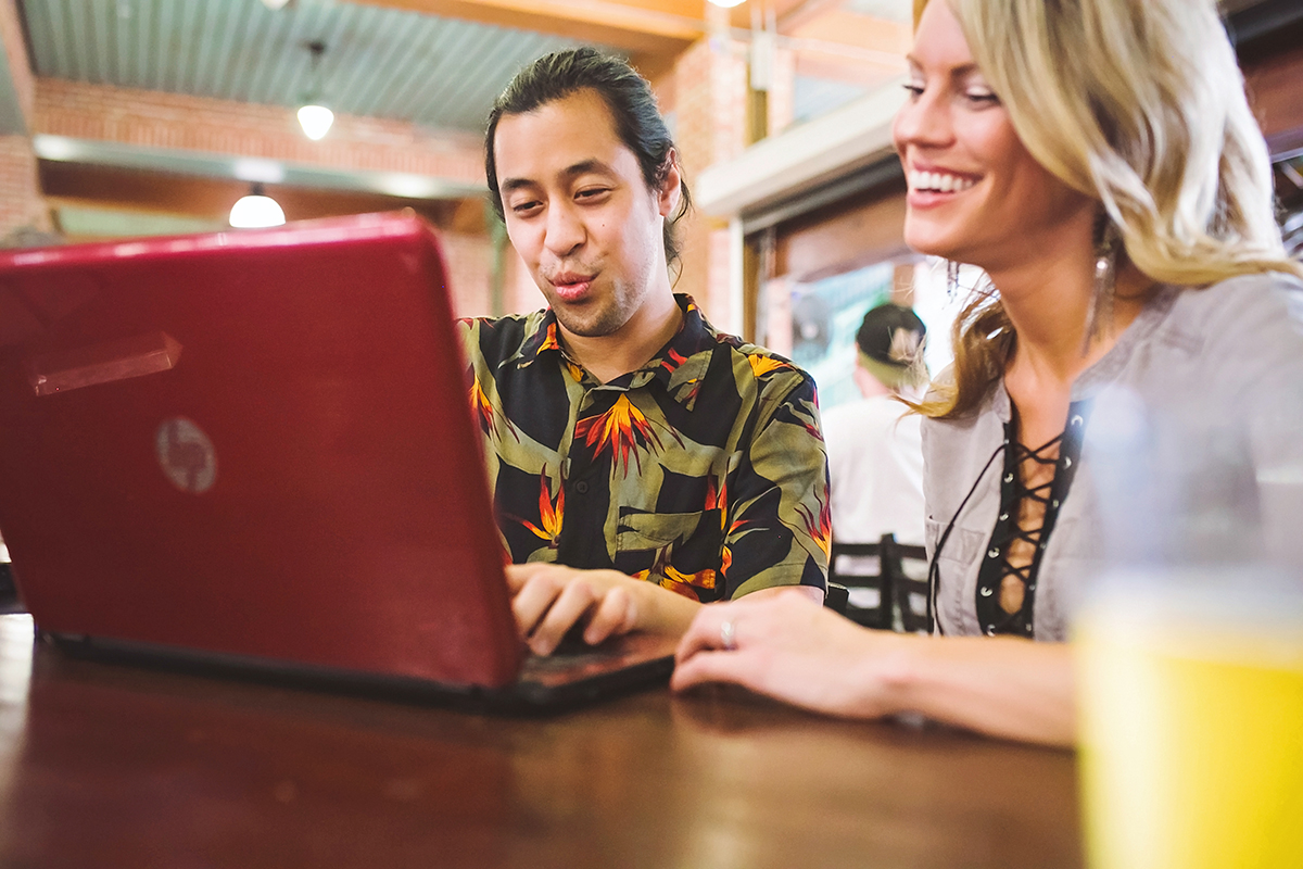 Two young people network over drinks at a local restaurant.