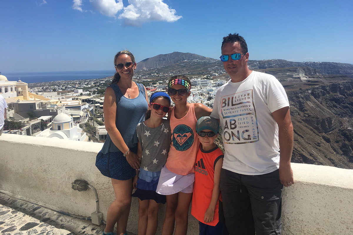 David Minogue, right, and his family standing in front of scenic background