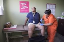 Kyle Hollingsworth, a transgender male, gets a testosterone shot in Orlando, Fla.