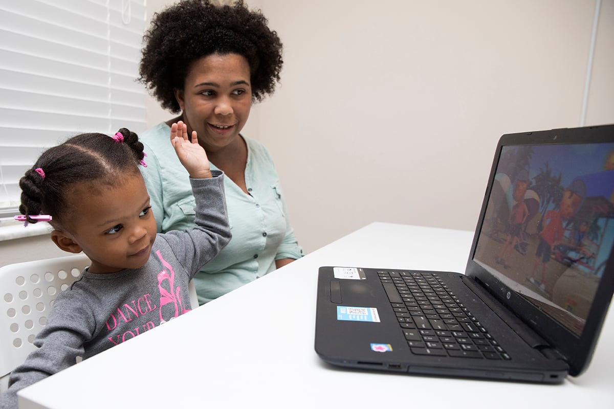 Carlena Dow, 2, and her mother, Nicole Dow, watch Kids TV — Nursery Rhymes and Baby Songs on Youtube in their home .