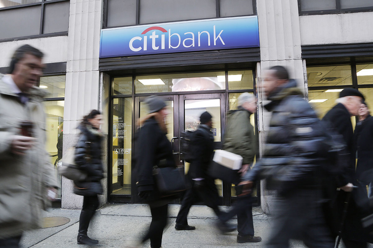 People walk past a New York branch office of Citibank