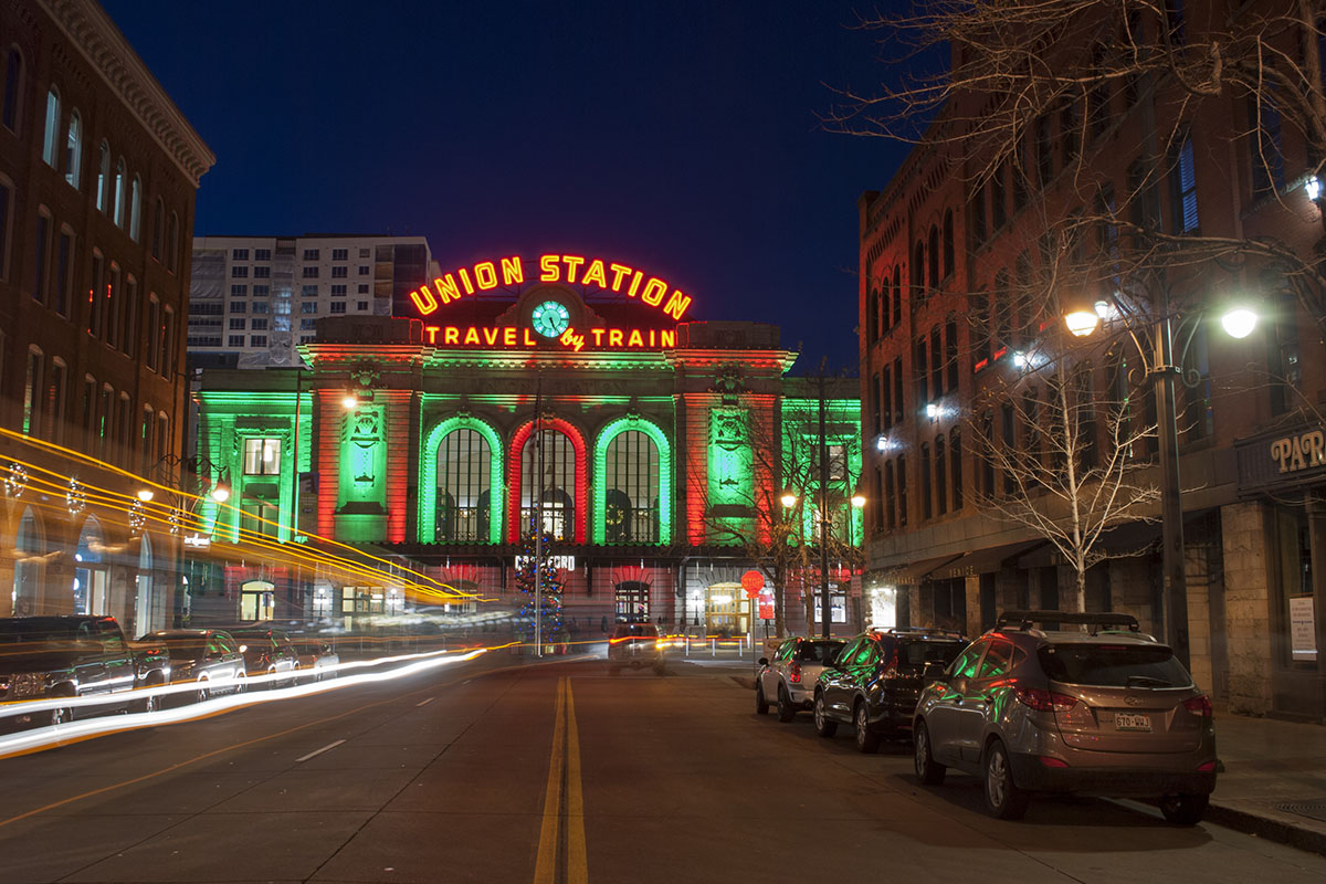 View of Union Station in downtown Denver, Colorado, taken at night from the middle of a street.