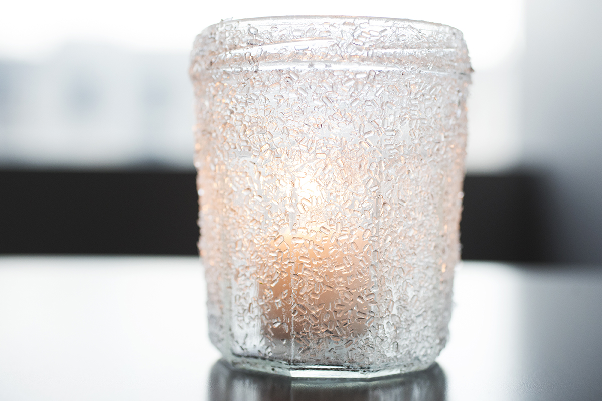 A wintery candle is an easy, inexpensive DIY Christmas decoration you can make with your children.