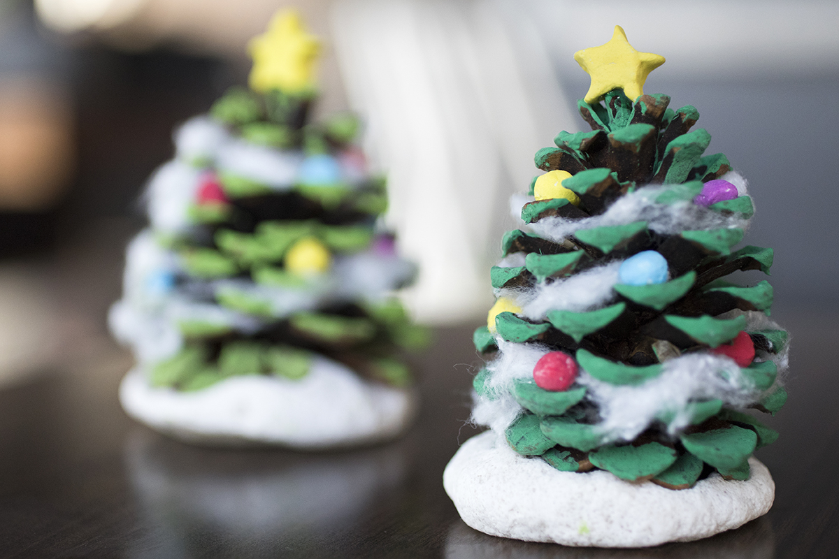 Pinecones, green paint and salt dough are the only things you'll need to make miniature Christmas trees with your little ones for Christmas decorations
