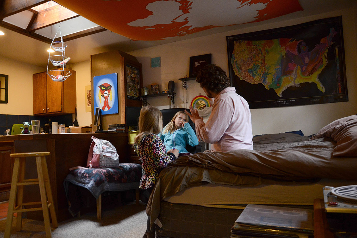 TC Bell sits with his two daughters Dagny, 8 and Emma, 4 before they get dressed for school