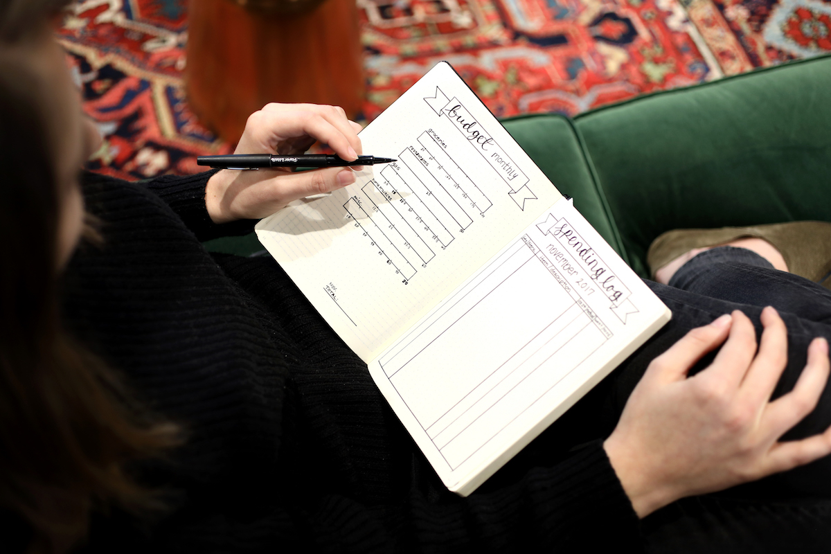 hands writing in a journal
