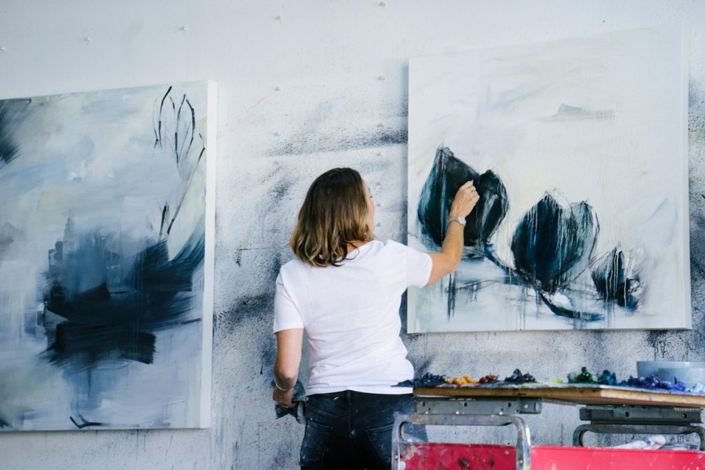 A woman paints in her studio.