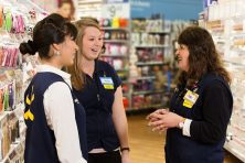 walmart associates meeting in the store to discuss plans