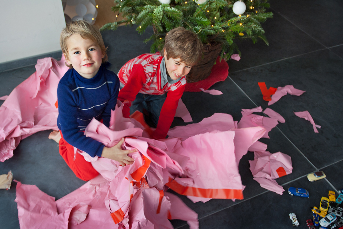 Two boys unwrapping Christmas presents, portrait