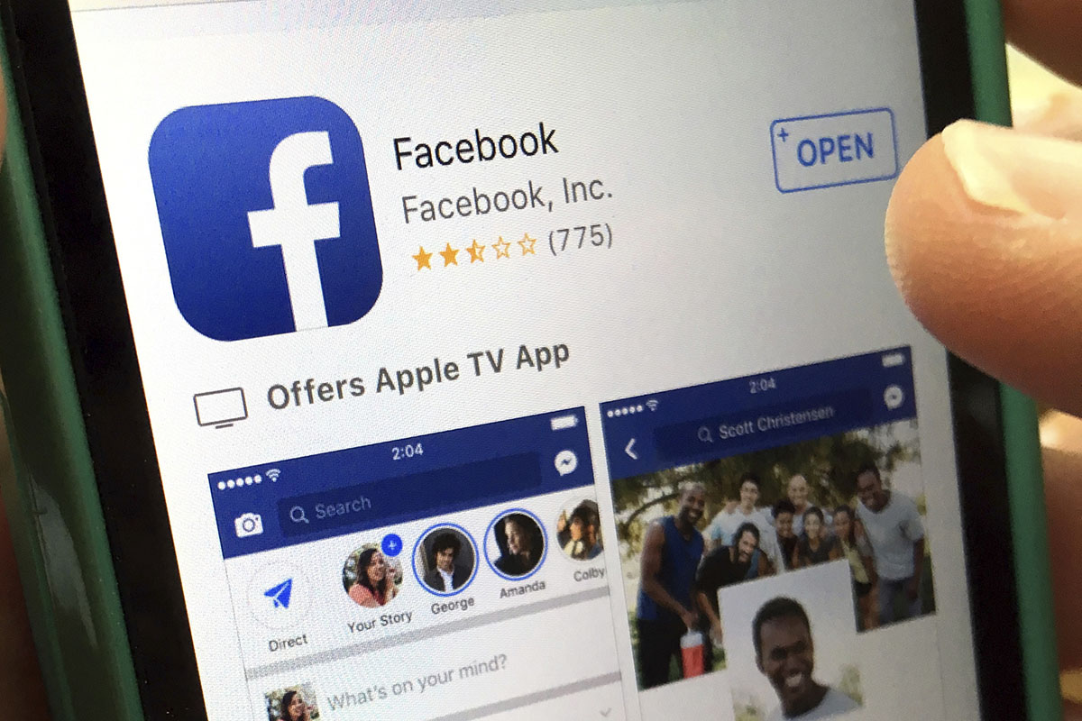 A user gets ready to launch Facebook on an iPhone, in North Andover, Mass