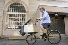 A mail carrier rides his bicycle in downtown St. Petersburg, Fla.