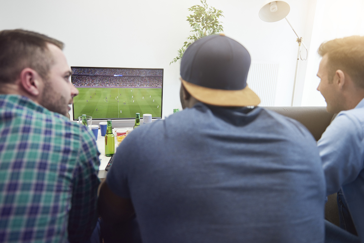 3 men watching TV