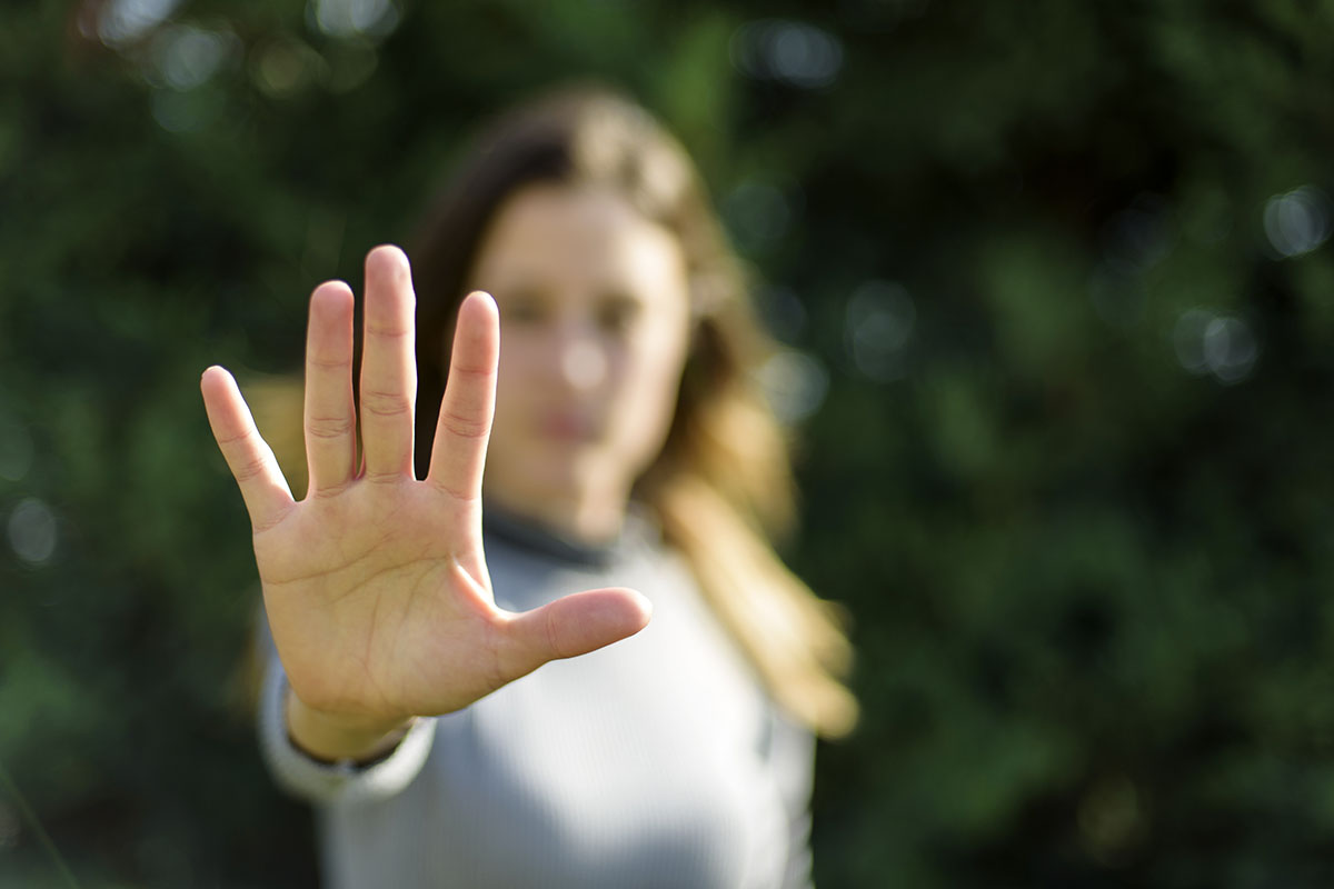 woman holding out hand in self defense