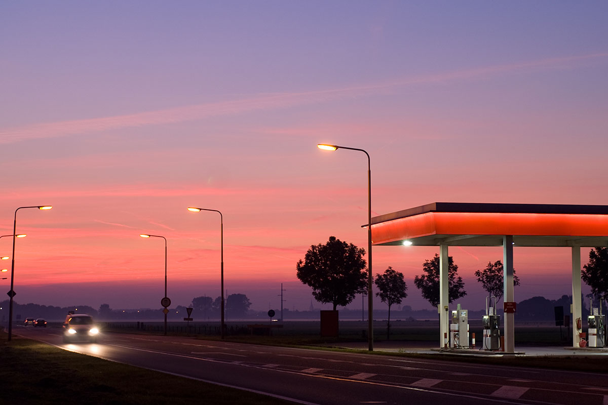 cars passing by a gas station.
