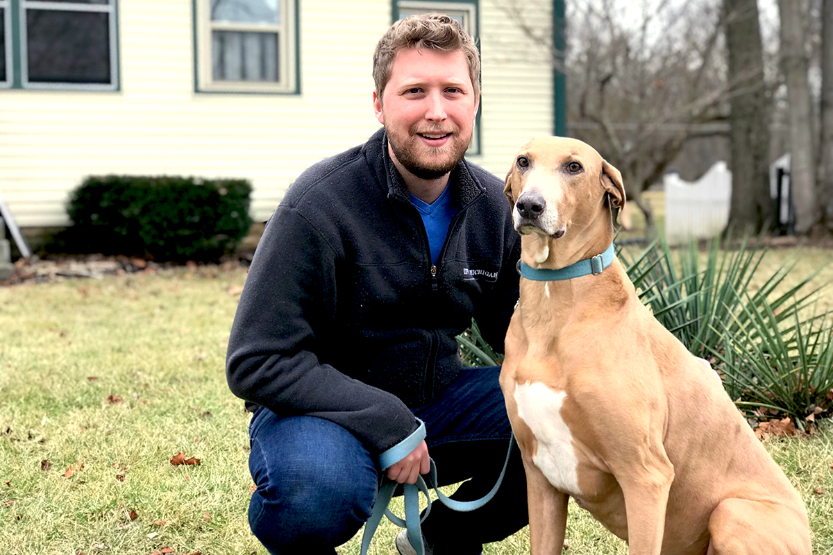 man posing with dog