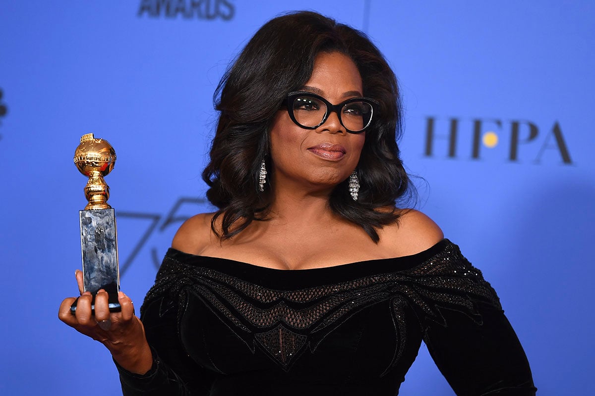Oprah Winfrey poses in the press room with the Cecil B. DeMille Award at the 75th annual Golden Globe Awards