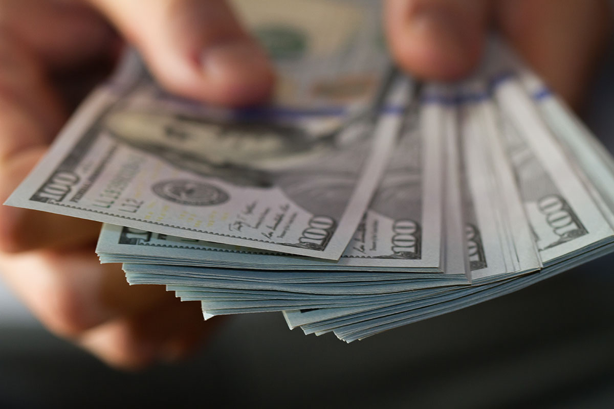 Fan of one hundred dollar bills in hands