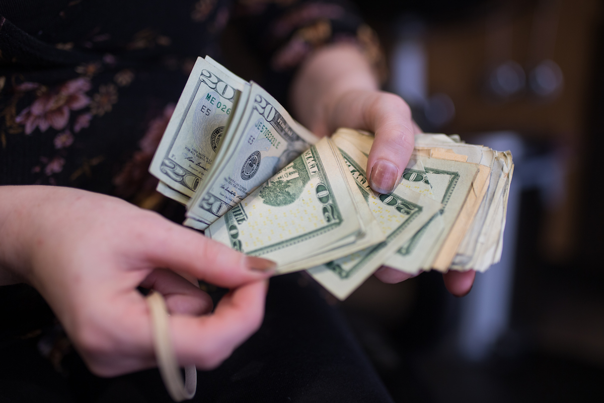hands sorting through money