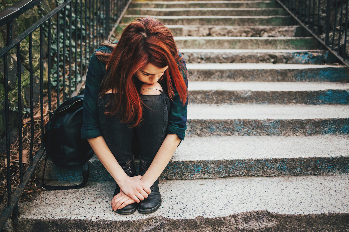 girl sitting on steps outside