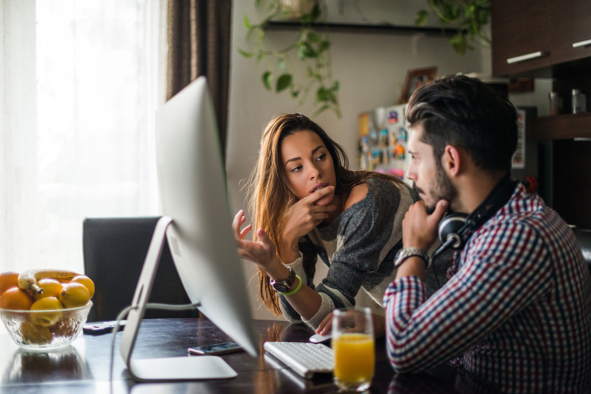 couple looking at computer together and discussing