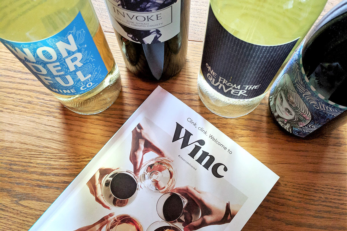 Winc guide next to wine bottles
