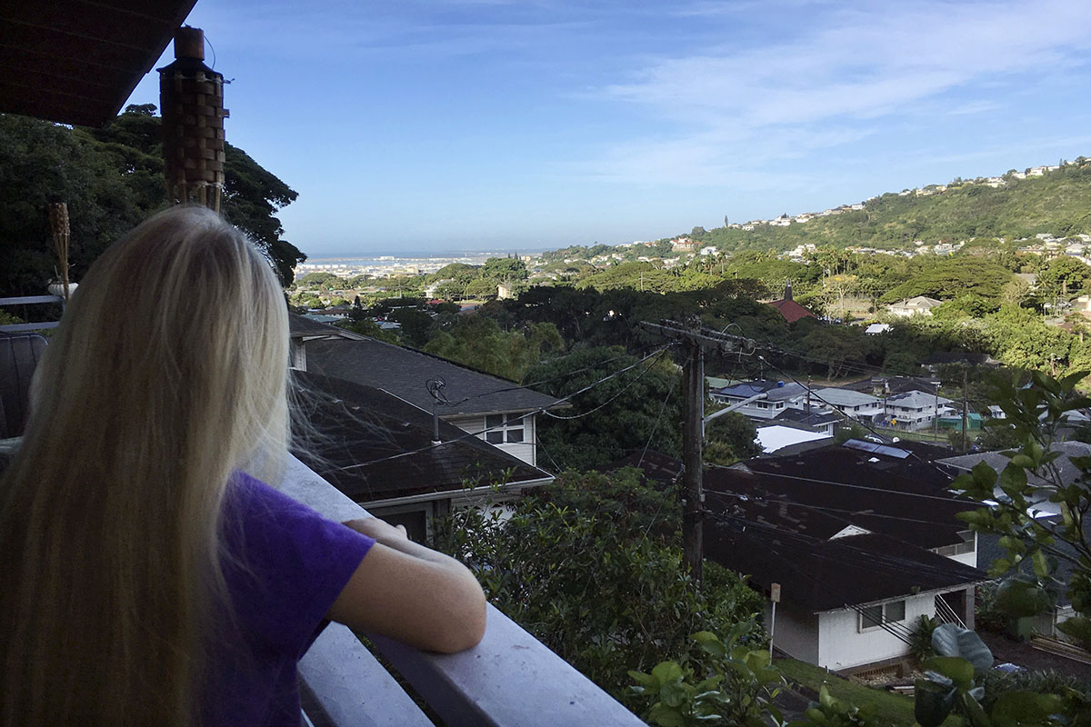 Caleb Jones' 7-year-old daughter looks out toward Pearl Harbor from their home in Honolulu