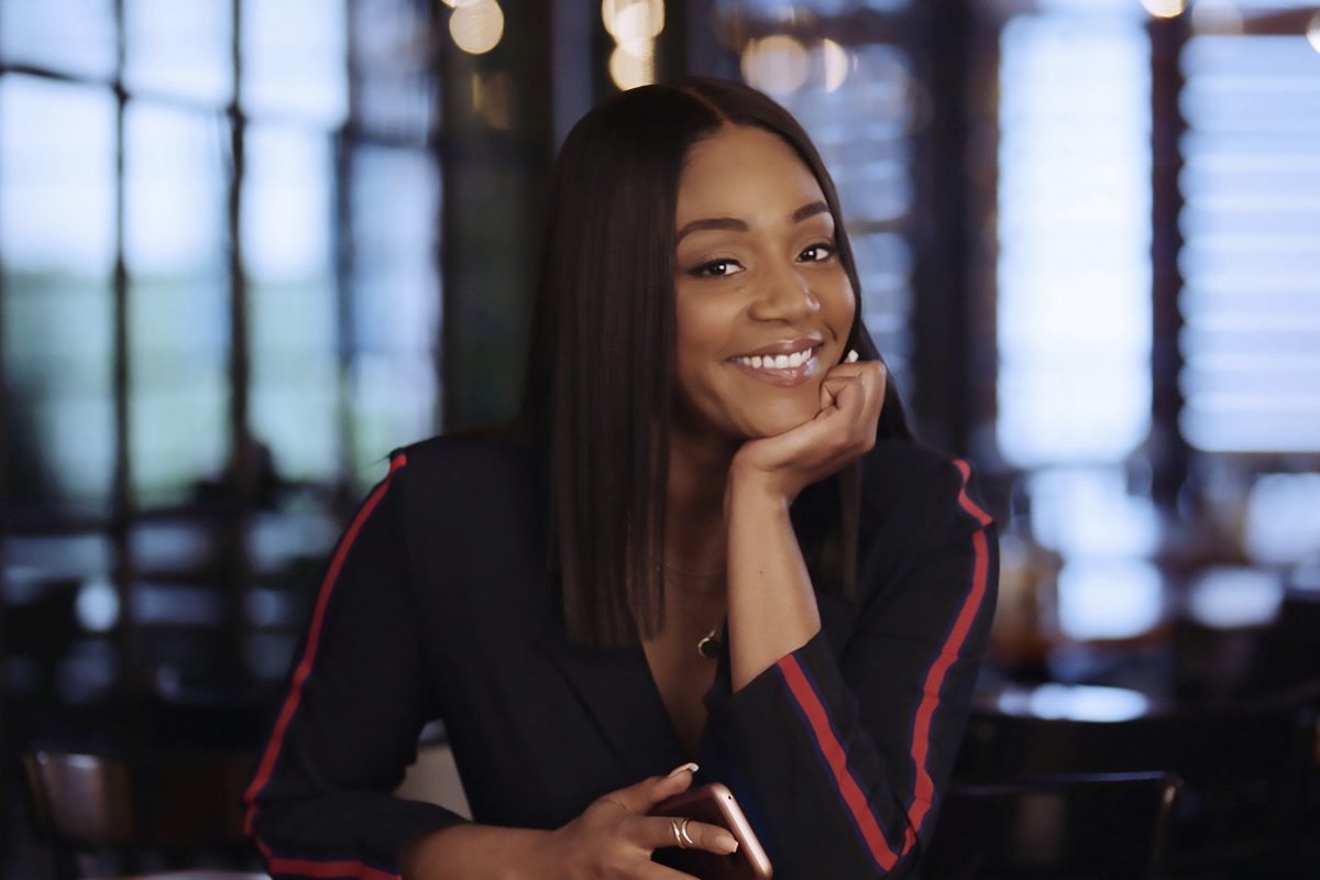 Tiffany Haddish poses with her cellphone.