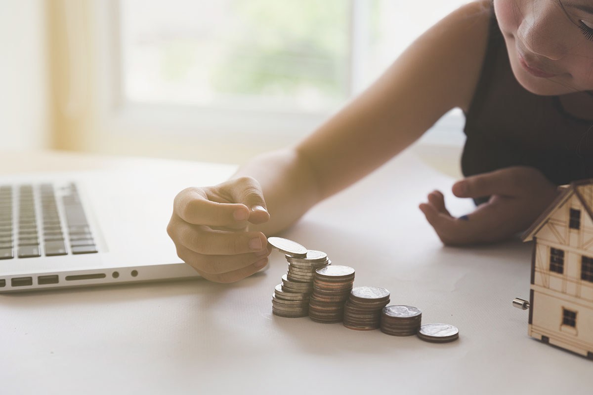 little girl stacking coins on a table