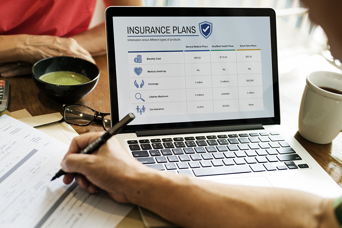 two people looking at insurance options on laptop