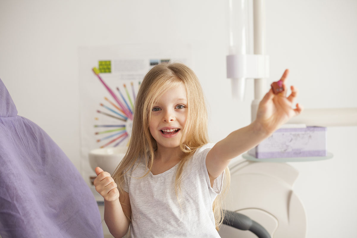 cute little girl at dentist office having fun