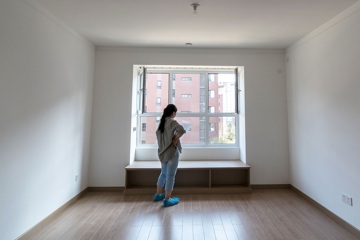 girl standing in empty apartment