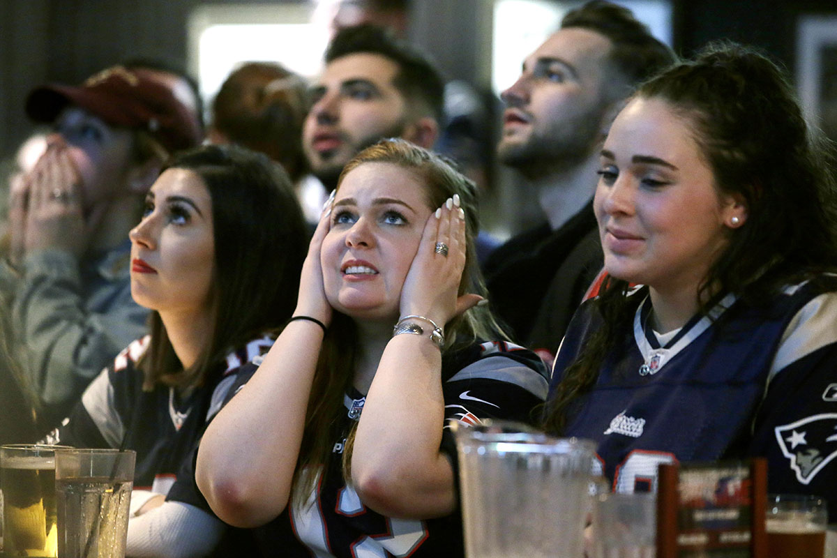 Kathleen Doherty, center, of Woburn, Mass., reacts with other fans while watching the NFL Super Bowl 52 football game between the New England Patriots and the Philadelphia Eagles in Minneapolis