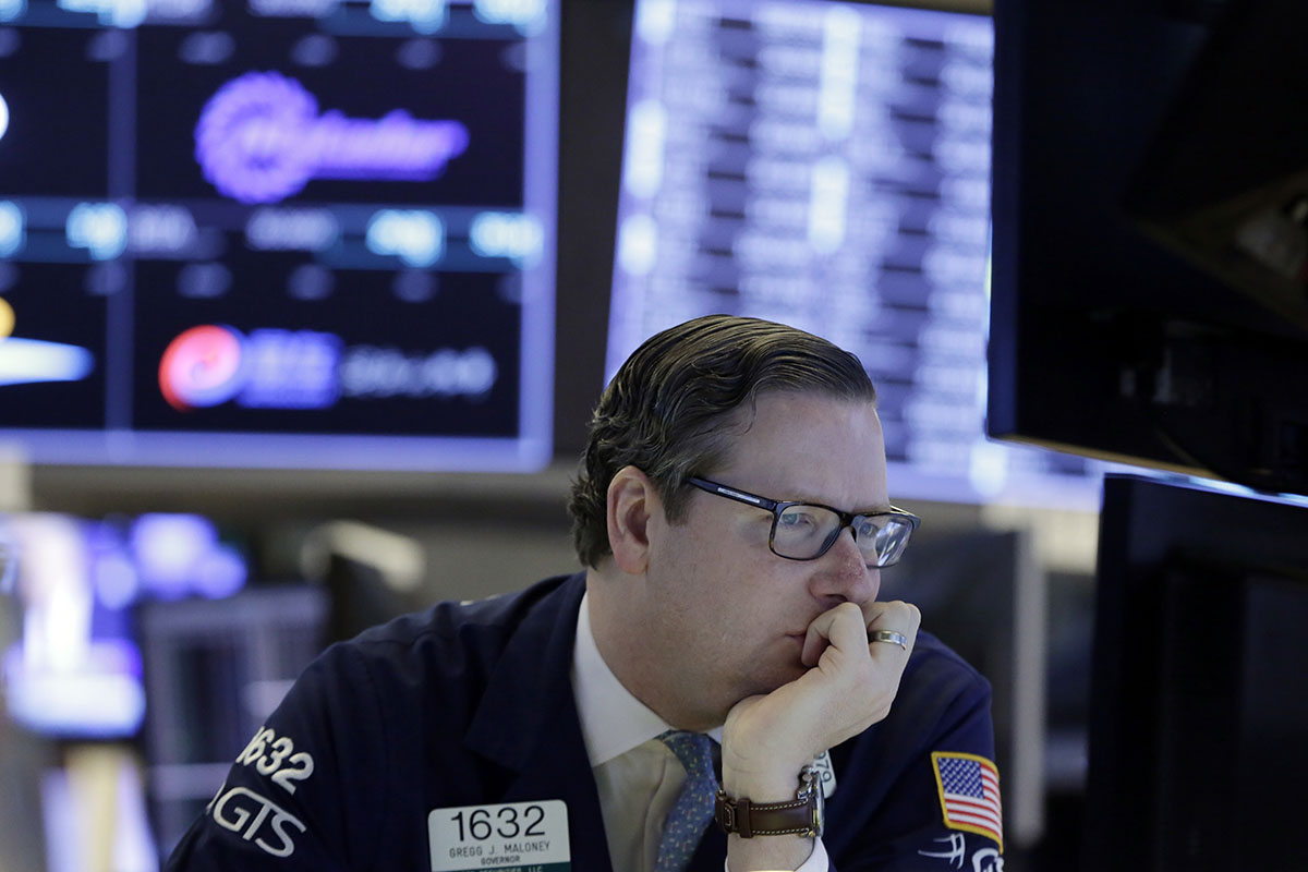 Specialist Gregg Maloney works at his post on the floor of the New York Stock Exchange, Wednesday, Feb. 7, 2018.
