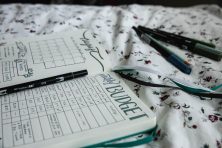 An open budget journal is on a bed.