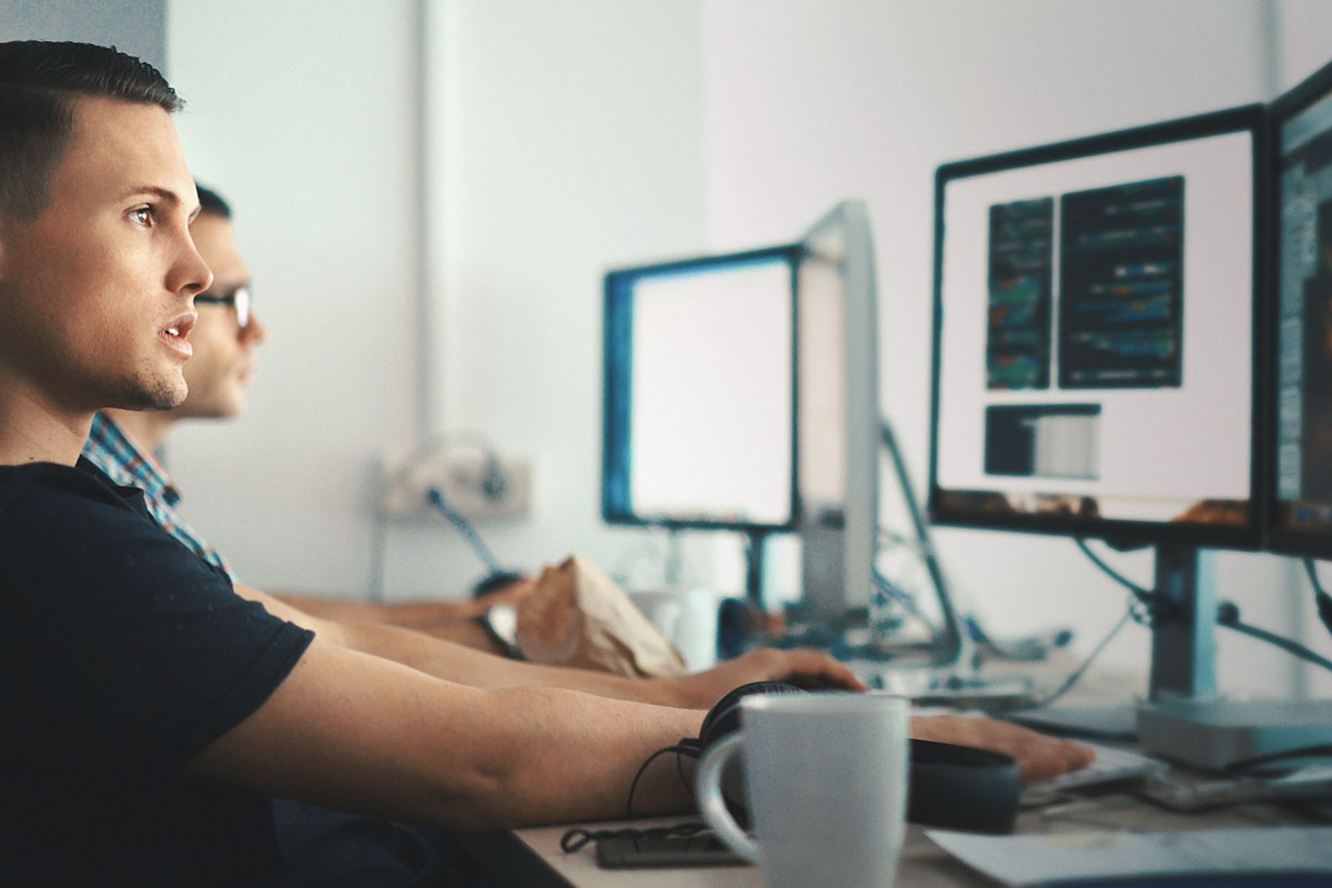 tech support sitting at desks working on computers