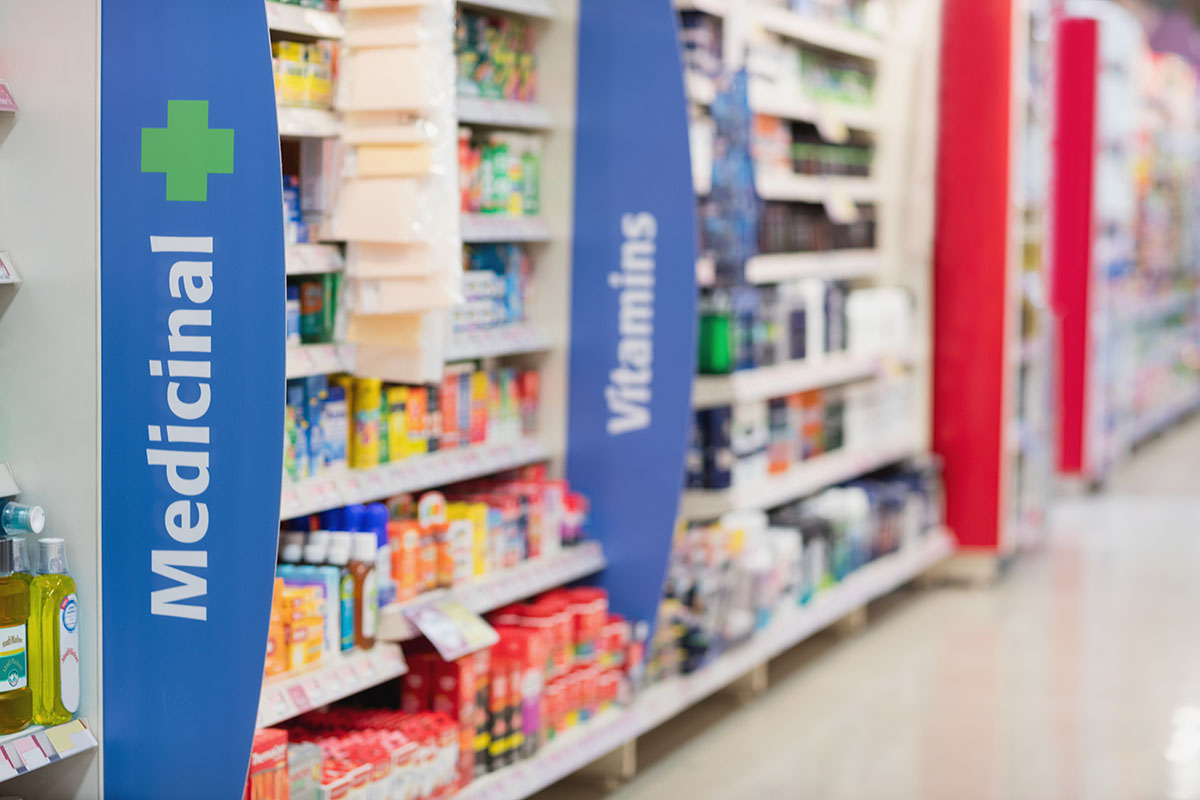 Side view of medicine shelves in grocery store