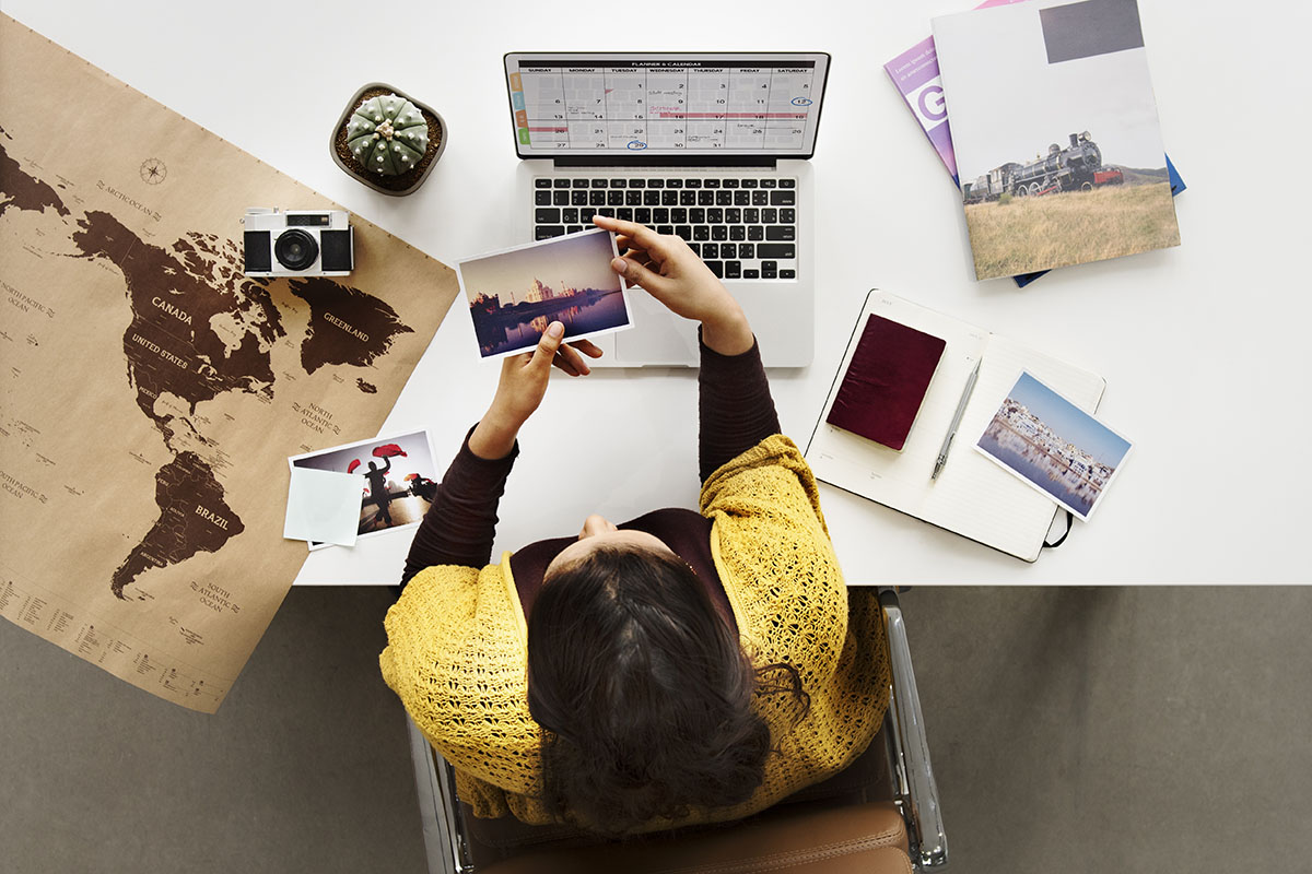 woman planning trip on laptop at home