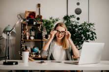 woman smiling at her office desk