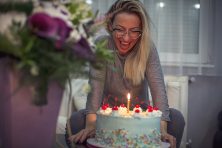 woman with flowers and her birthday cake