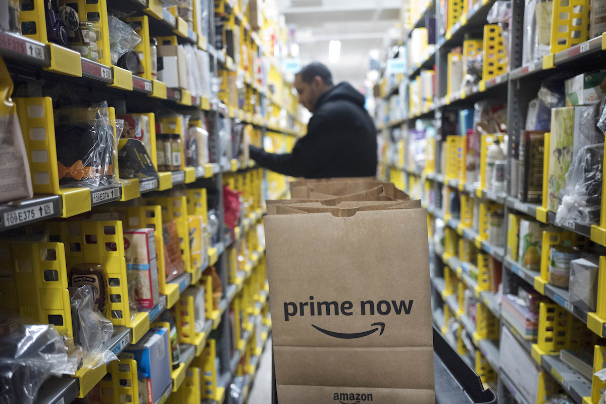 A clerk picks an item for an order at the Amazon Prime warehouse, in New York on Dec. 20, 2017. AP Photo/Mark Lennihan