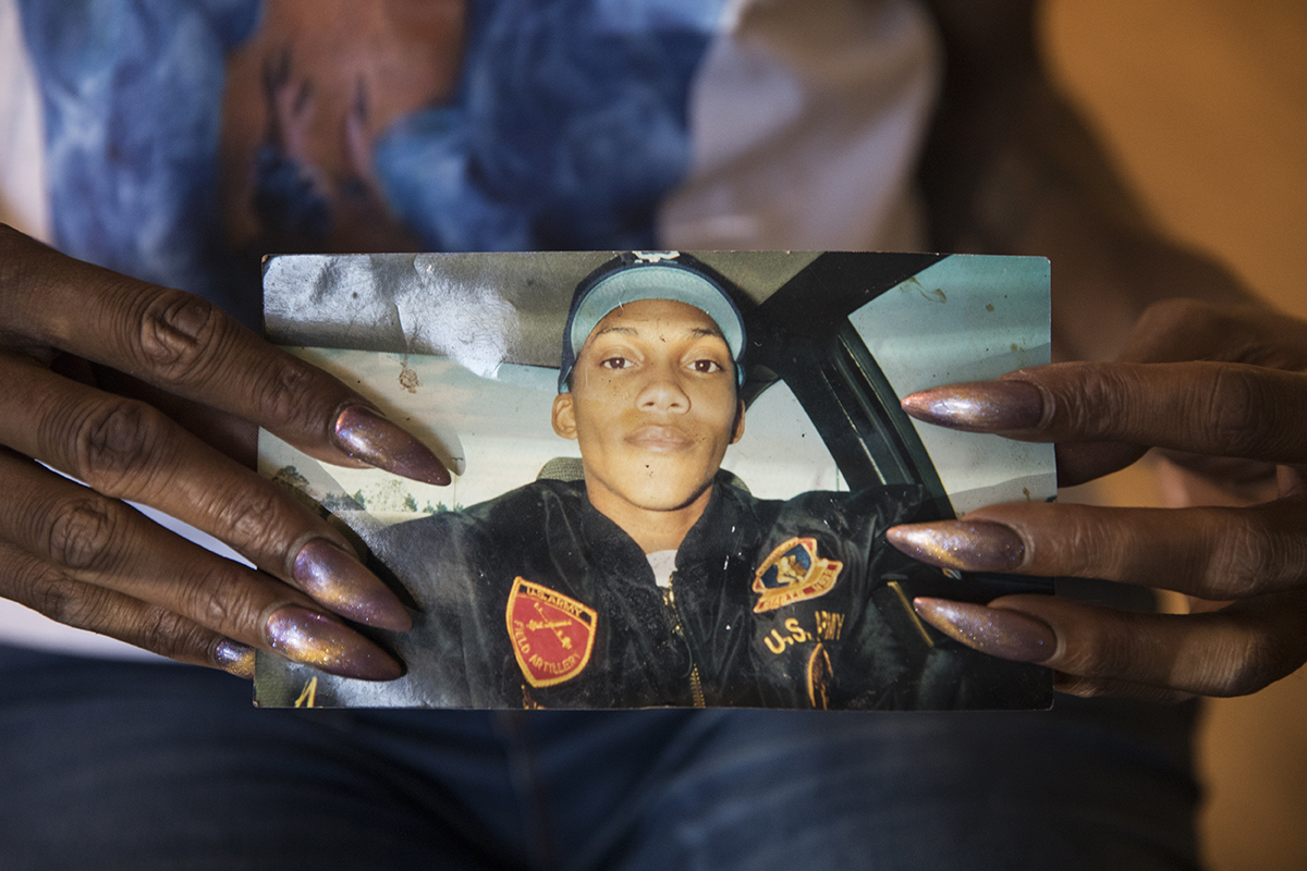 Taliyah Cassadine shows a photo of what she used to look like before she transitioned while serving in the military in 2000.