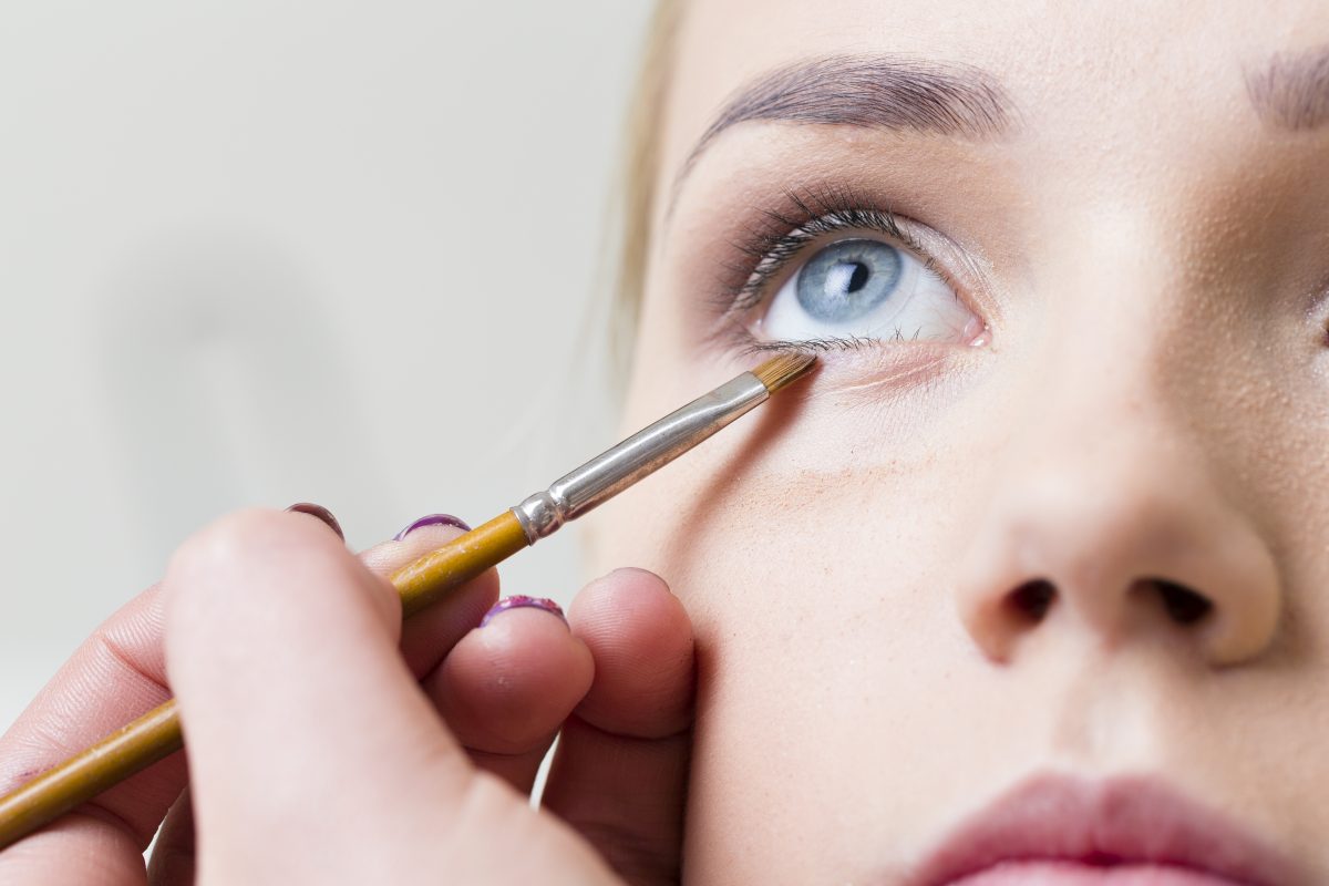 A woman gets her makeup professionally done.