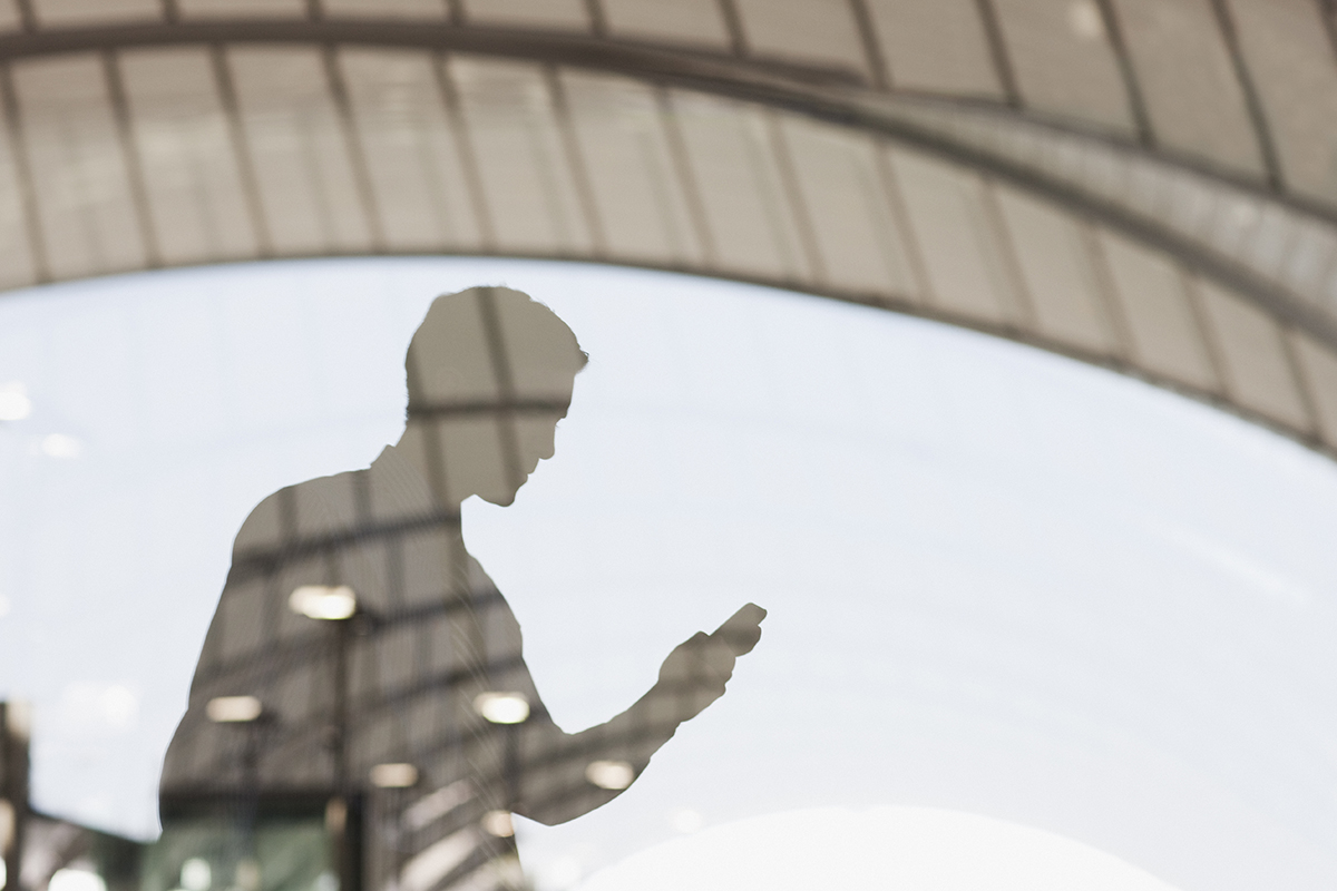 Businessman text messaging on cell phone