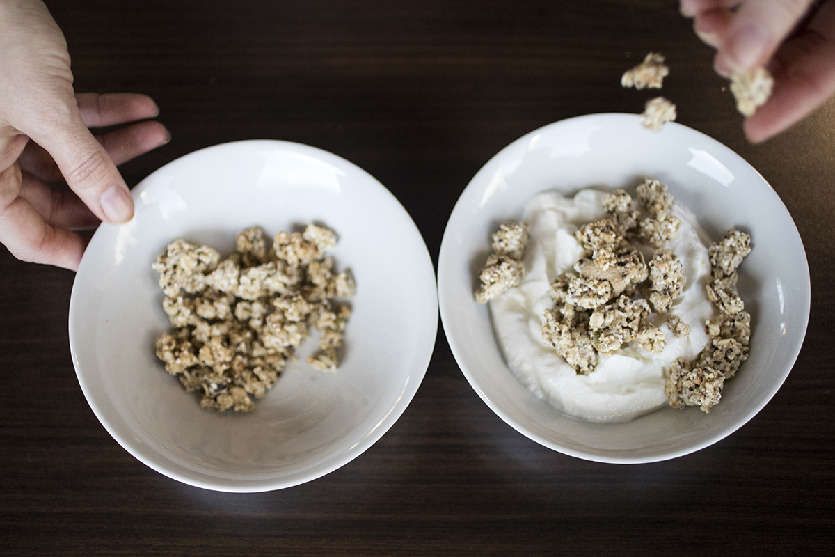 Granola is placed on Greek yogurt.