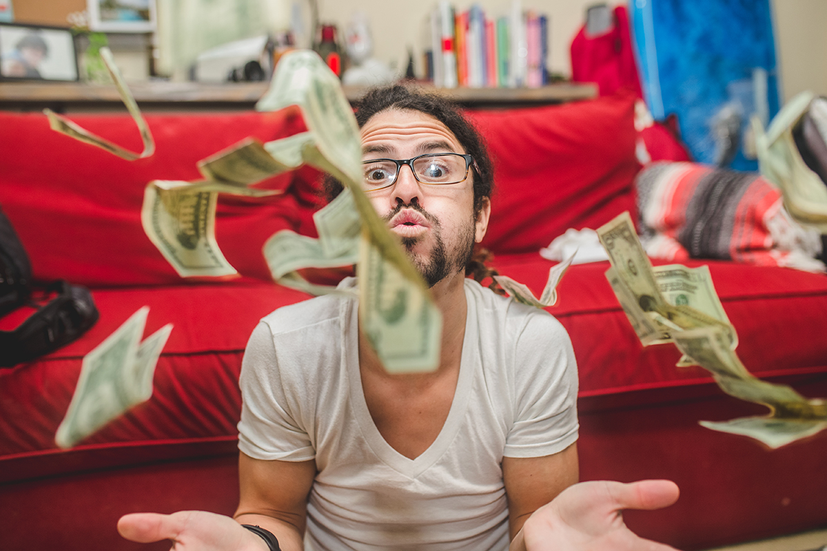 A man throws a pile of money.