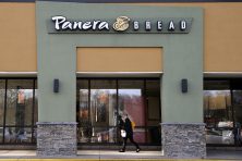 A passer-by walks near an entrance to a Panera Bread restaurant location, in Natick, Mass., on April 12, 2017. AP Photo/Steven Senne