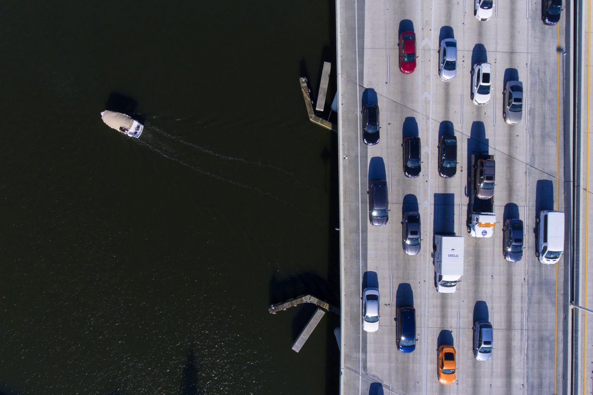 Cars sit in traffic on a bridge.