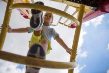 A child climbs up a ladder on a playground