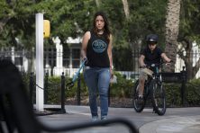 A woman picks up garbage at her local park.